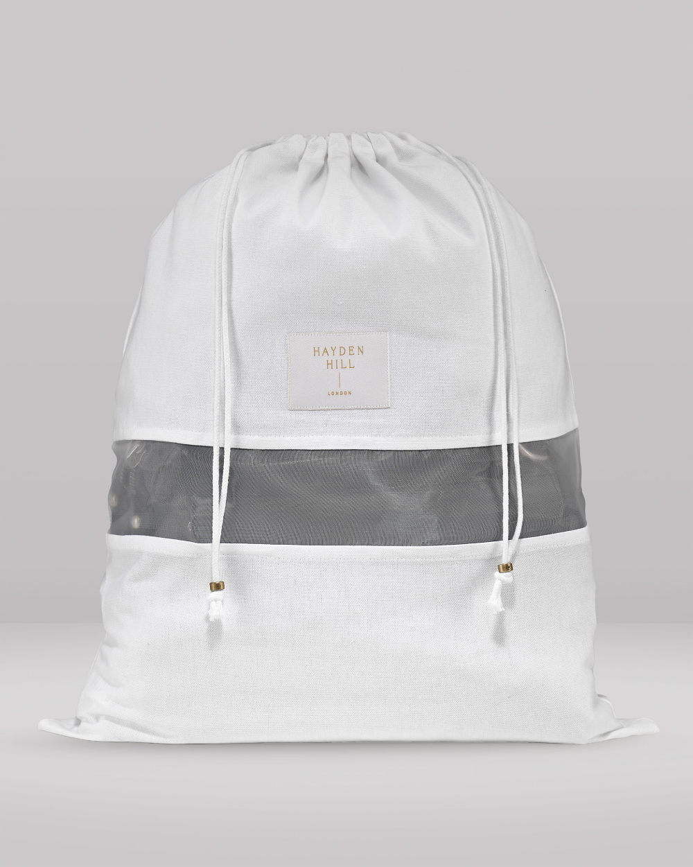 A white drawstring backpack with a semi-transparent gray mesh band across the middle and a small white brand patch reading 'HAYDEN HILL' on the front, shown against a neutral gray background.