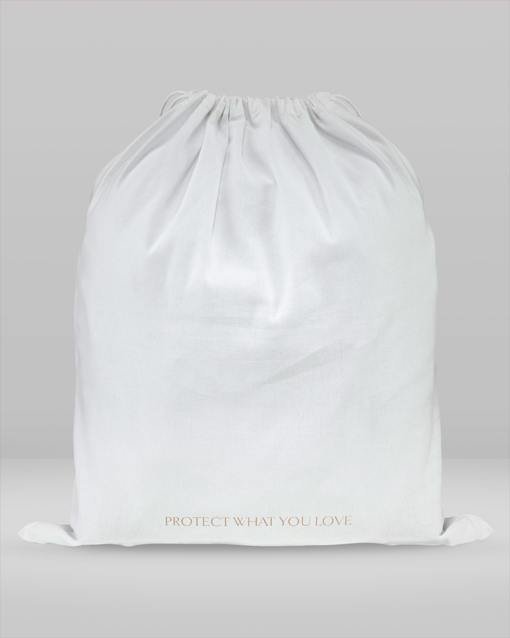 White drawstring bag with 'Protect What You Love' text on a light grey background