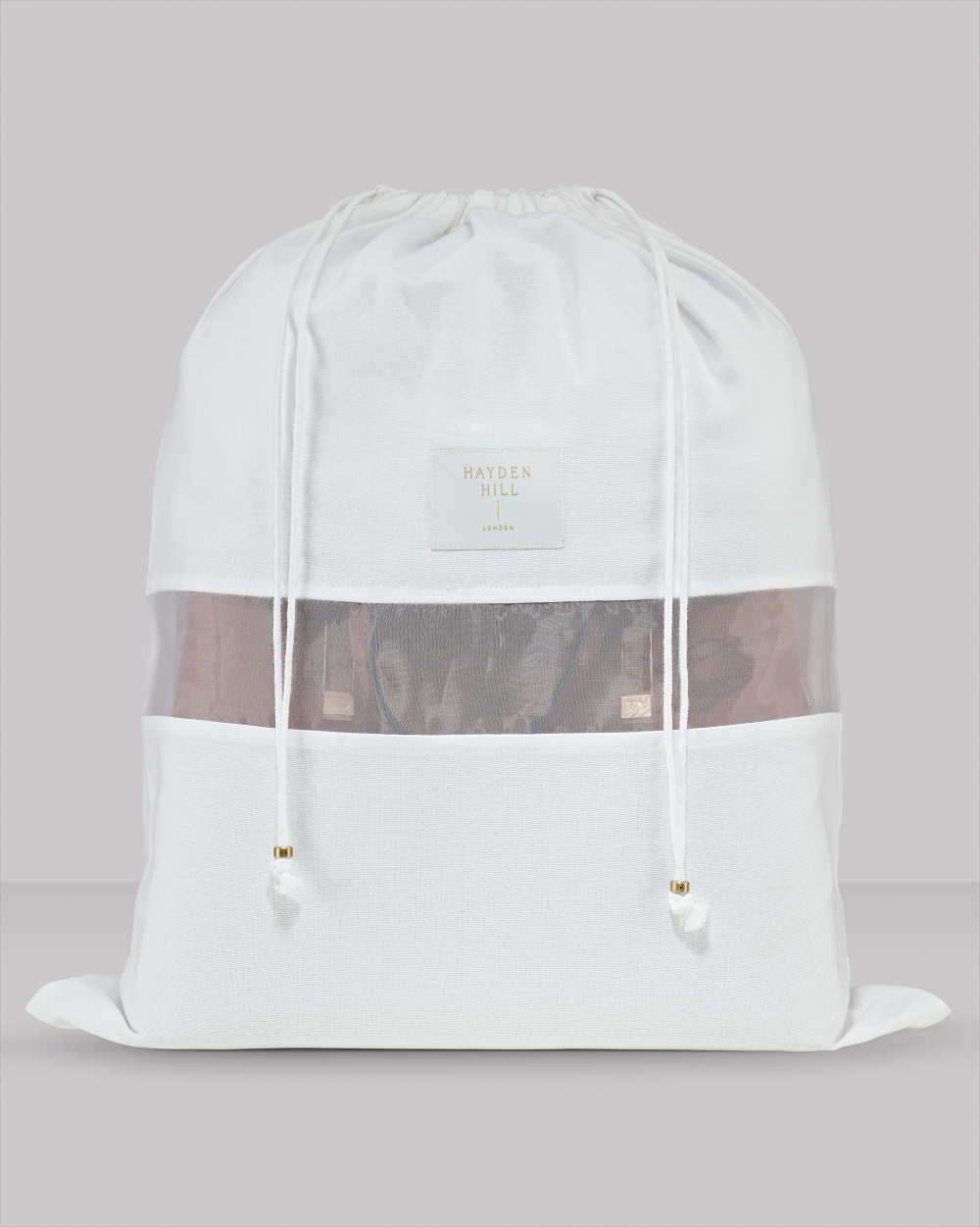 White drawstring bag with mesh side panels on a light grey background