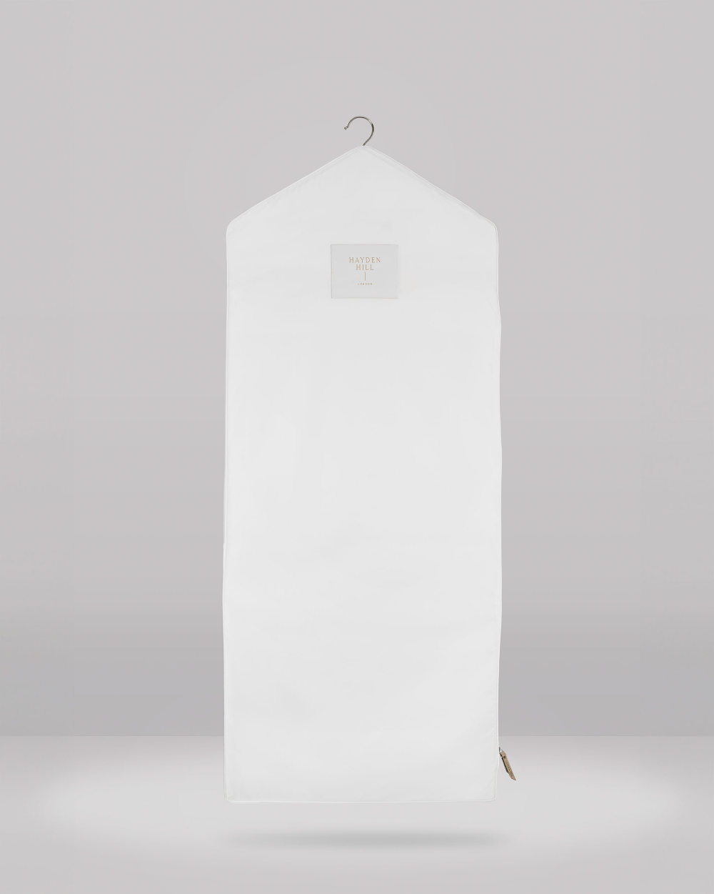 White hanging garment bag on a grey background