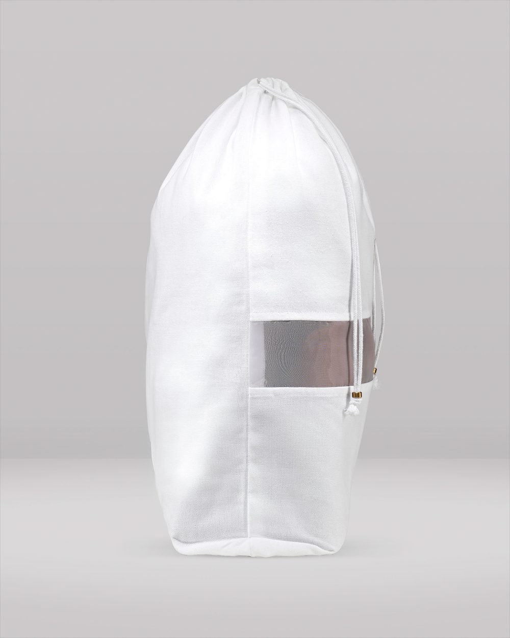 White drawstring garment bag with mesh panel on a grey background
