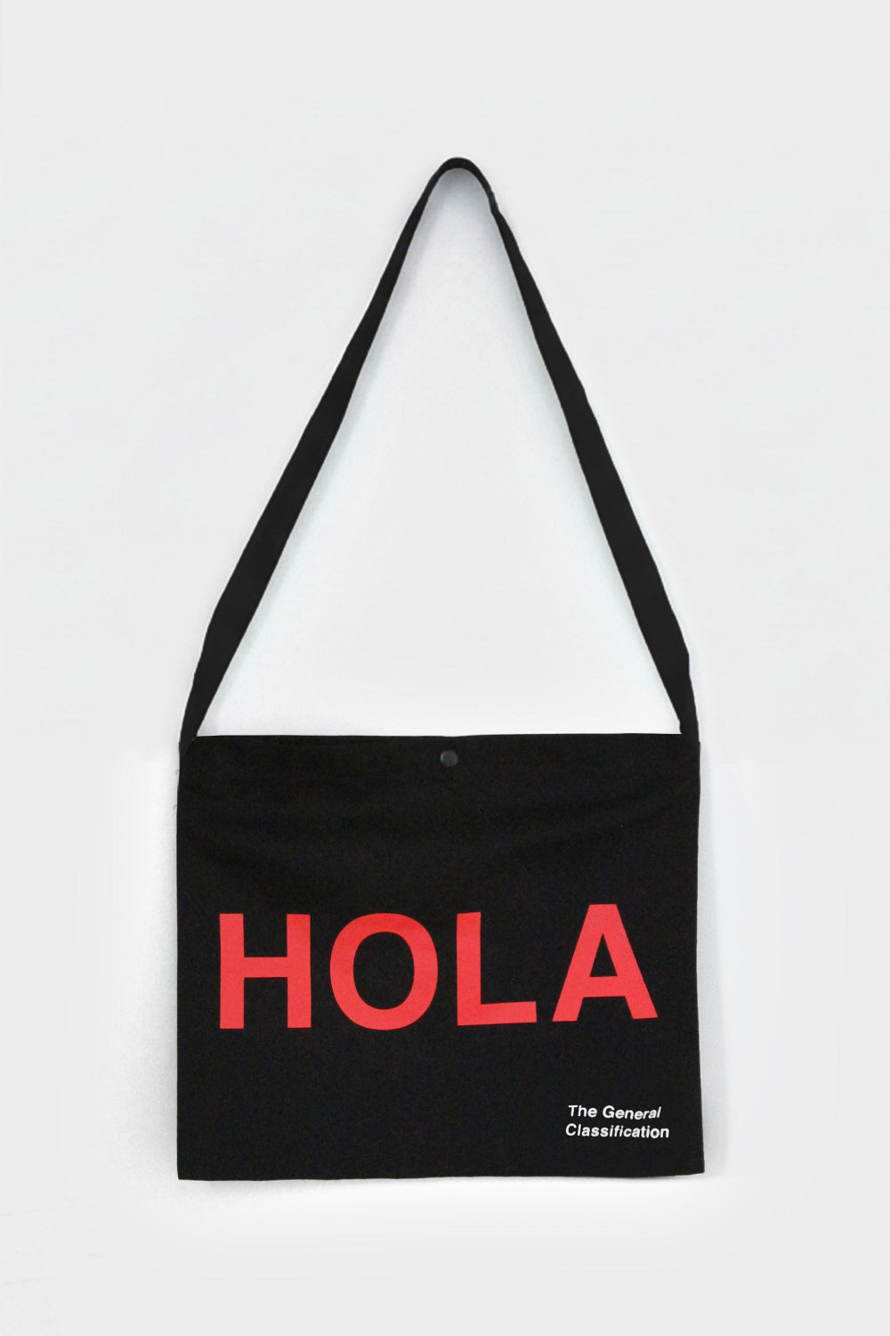 Black tote bag with 'HOLA' in red text on a white background