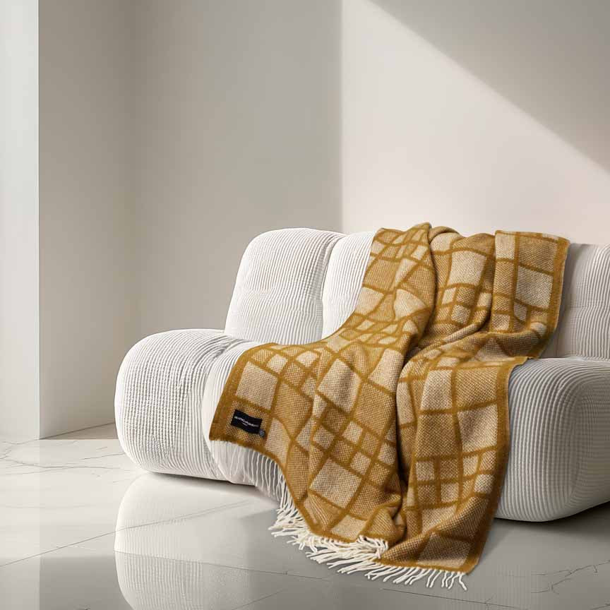 Yellow checkered blanket draped over a white armchair in a minimalistic room.