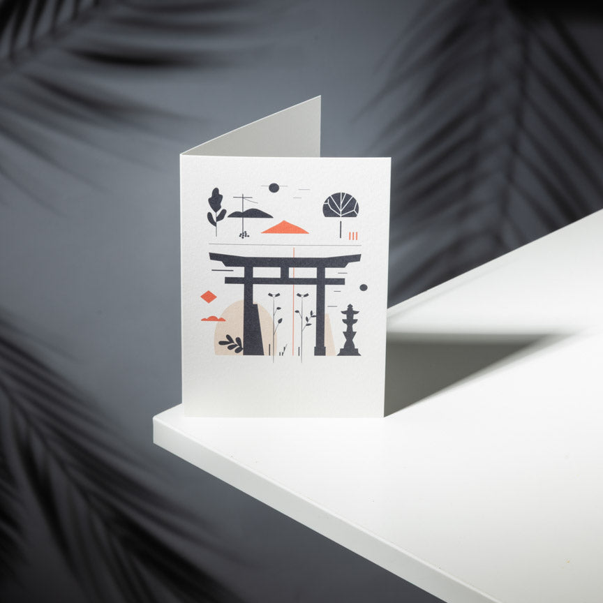 Greeting card with Japanese-themed design on a white surface with a dark background