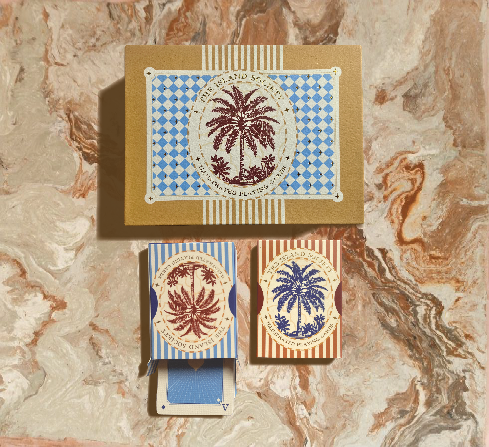 The Island Society luxury double deck playing cards with two illustrated card packs and a gold foil presentation box.