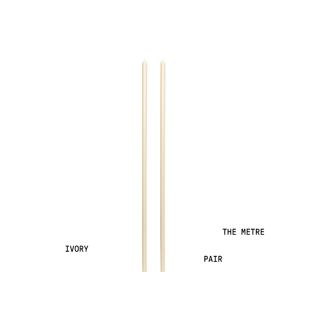 Two tapered candles labelled 'Ivory' and 'The Metre Pair' on a white background.