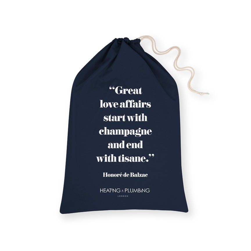 Navy drawstring bag with white text and branding on a white background