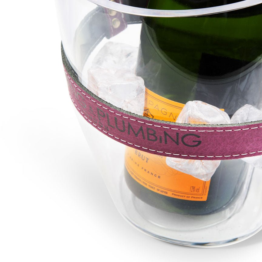 Bottle of champagne with a pink band labeled 'Heating and Plumbing' on a white background