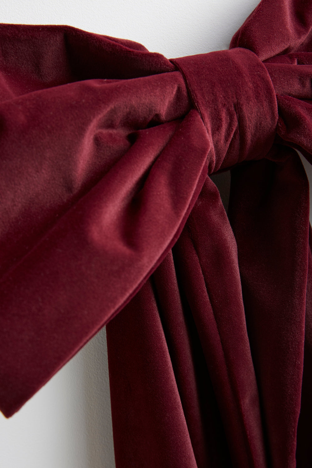 Detail of the burgundy upholstery-grade velvet used for the oversized bow