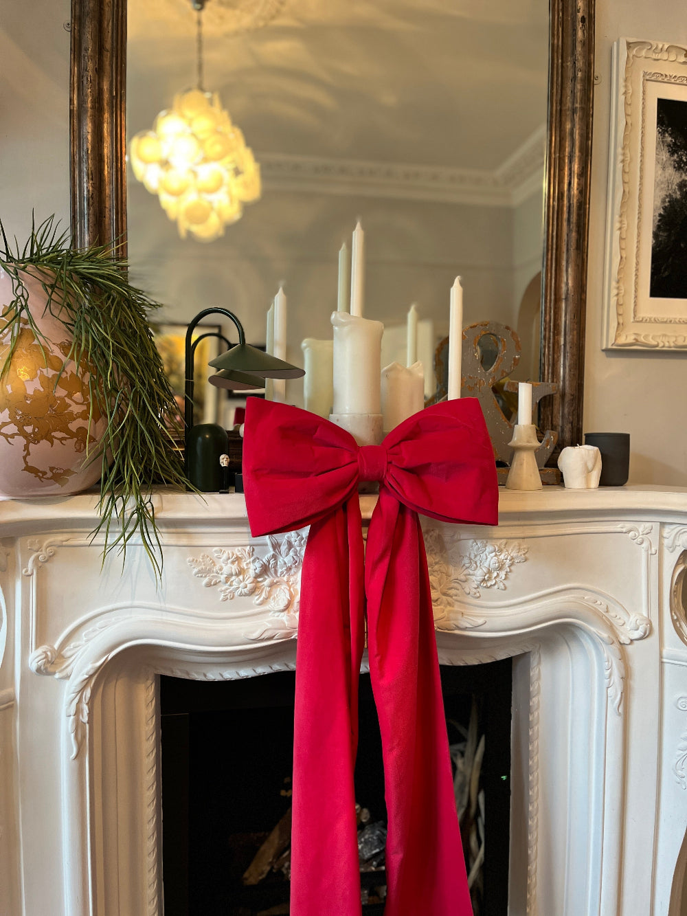 Kika Bespoke oversized hot pink velvet Christmas bow styled on a mantel