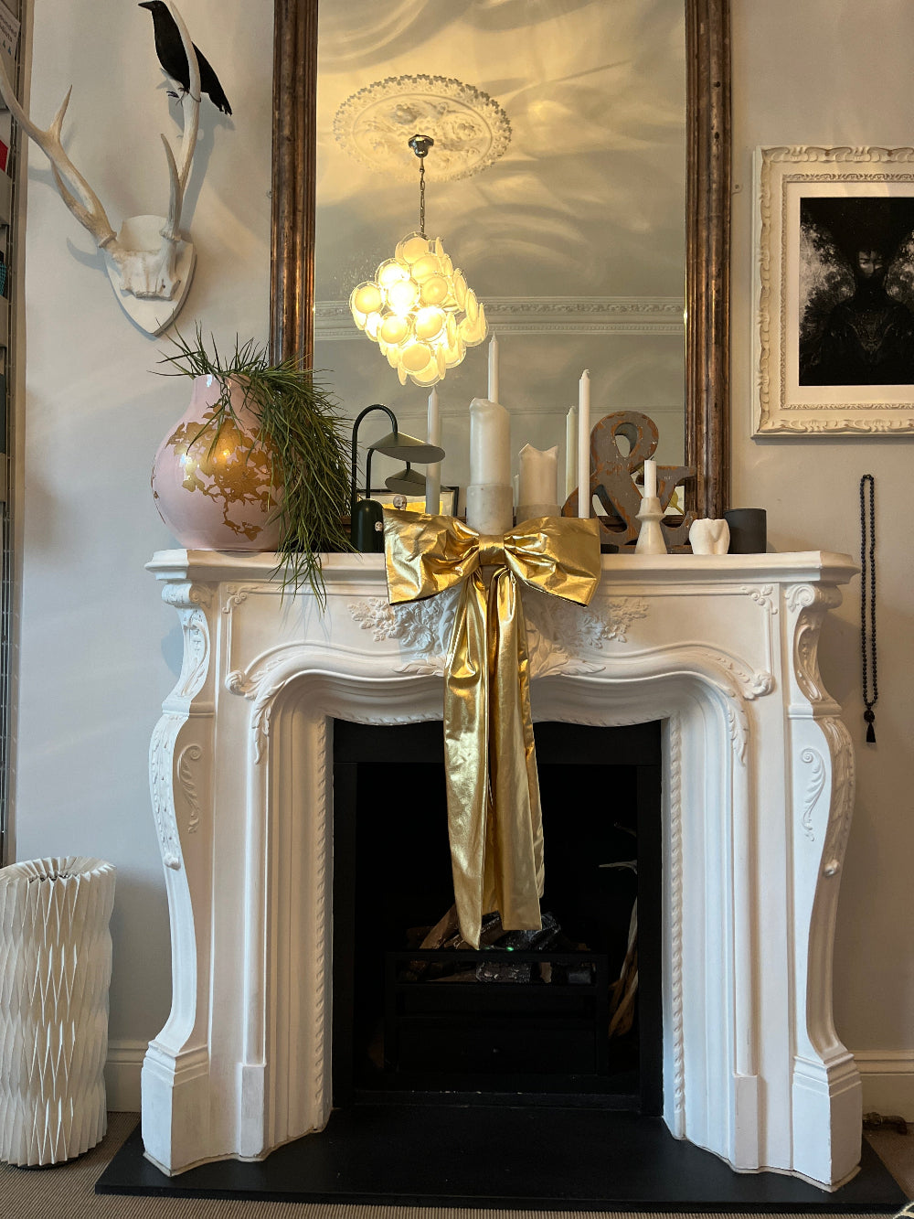 Kika Bespoke oversized gold foil Christmas bow styled on a mantel