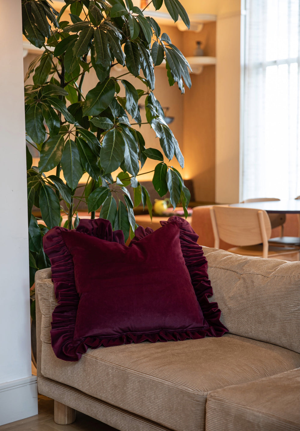 Kika Bespoke XL burgundy ruffled velvet cushion styled on a sofa