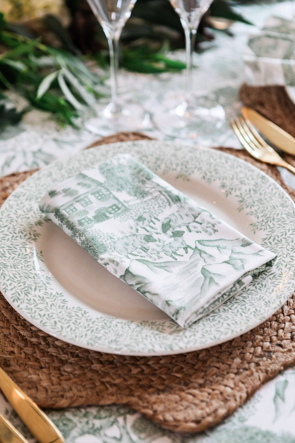 Elegant table setting with a plate, napkin, and cutlery on a woven placemat.