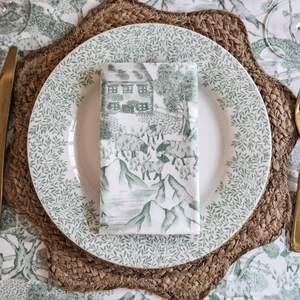 Table setting with a patterned plate, napkin, and placemat on a textured surface.