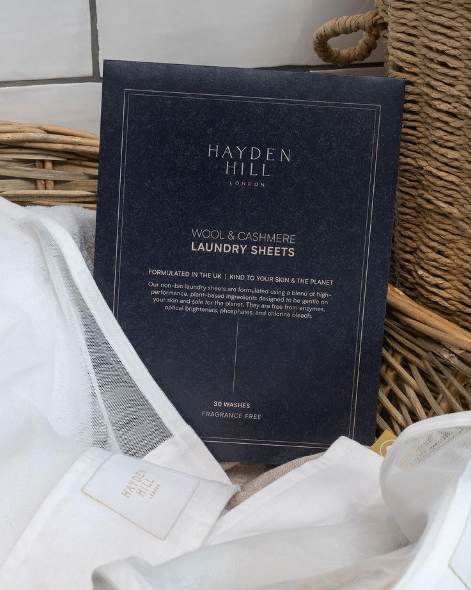 Hayden Hill laundry sheets packaging with white laundry in the background