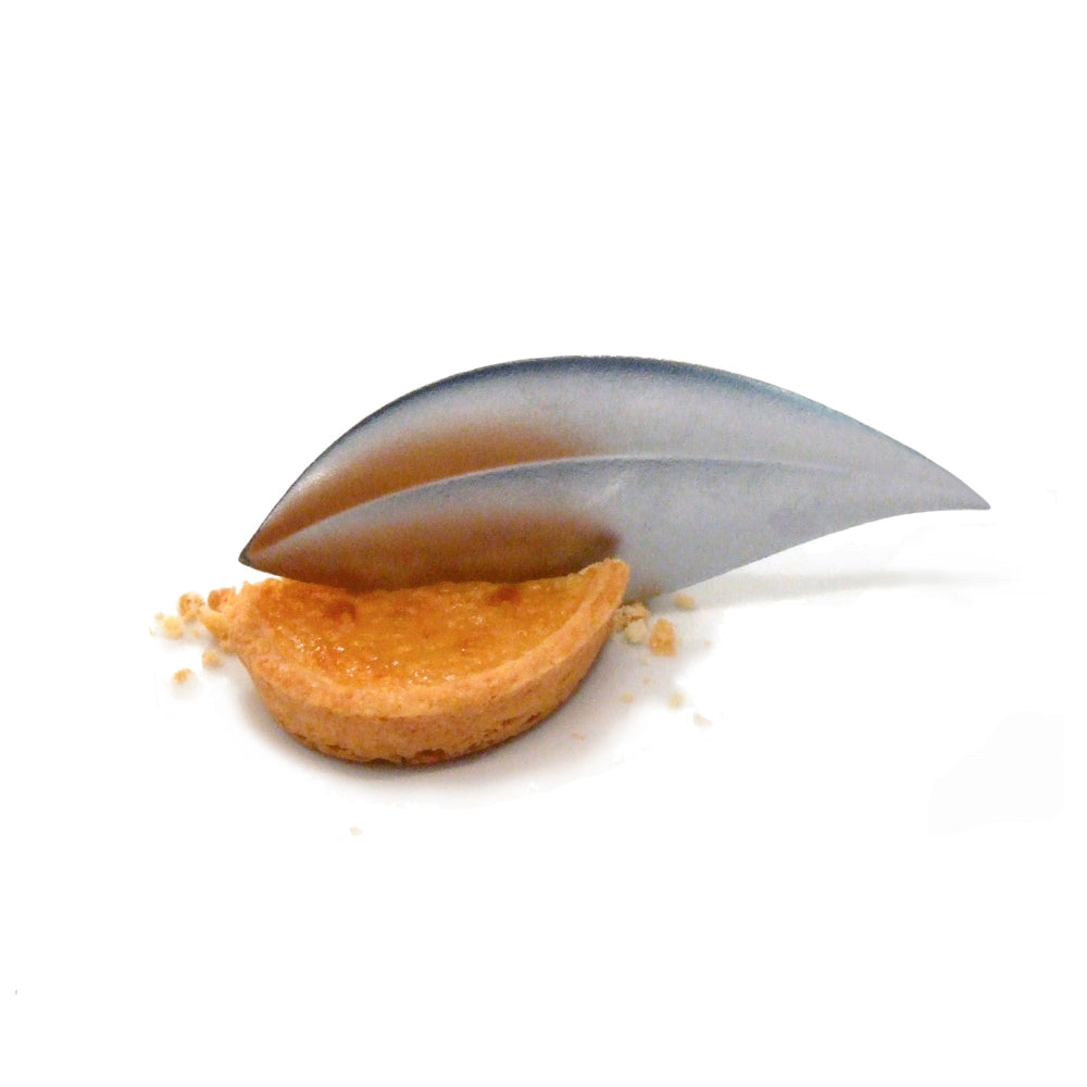 Small tart with a leaf spoon on a white background