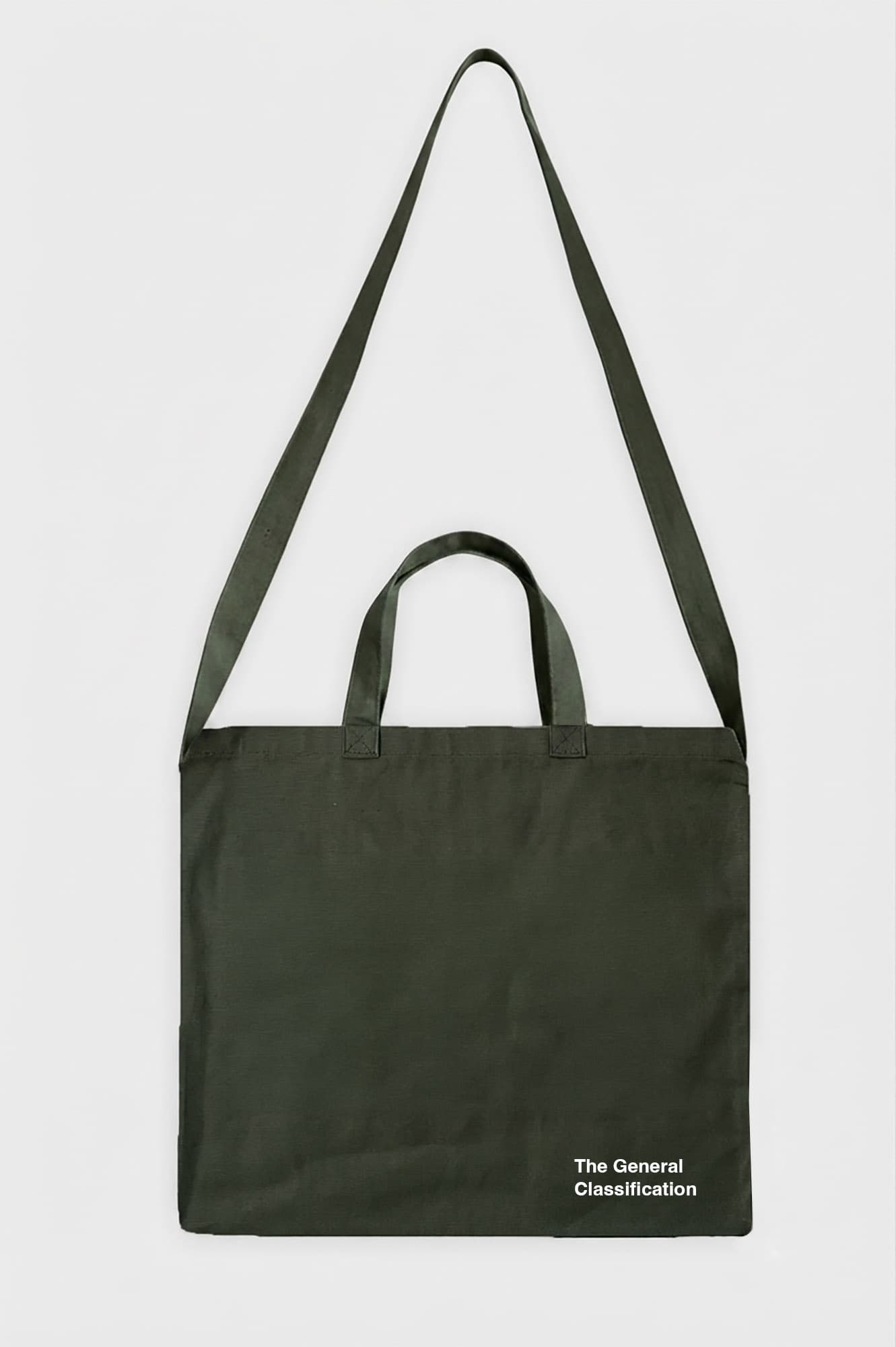 An olive green canvas tote bag with dual top handles and a long shoulder strap, featuring the white printed text 'The General Classification' in the bottom right corner, set against a plain light grey background.