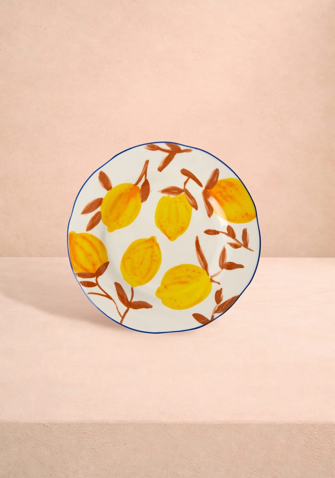 Decorative plate with lemon design on a beige background