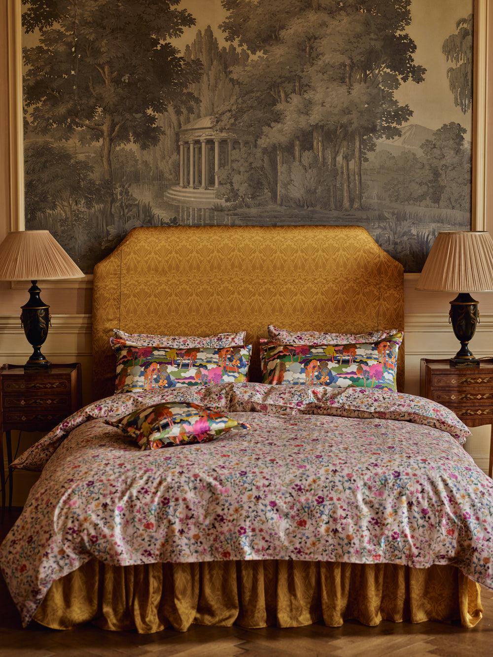 Bedroom with floral bedding and a large wall mural.