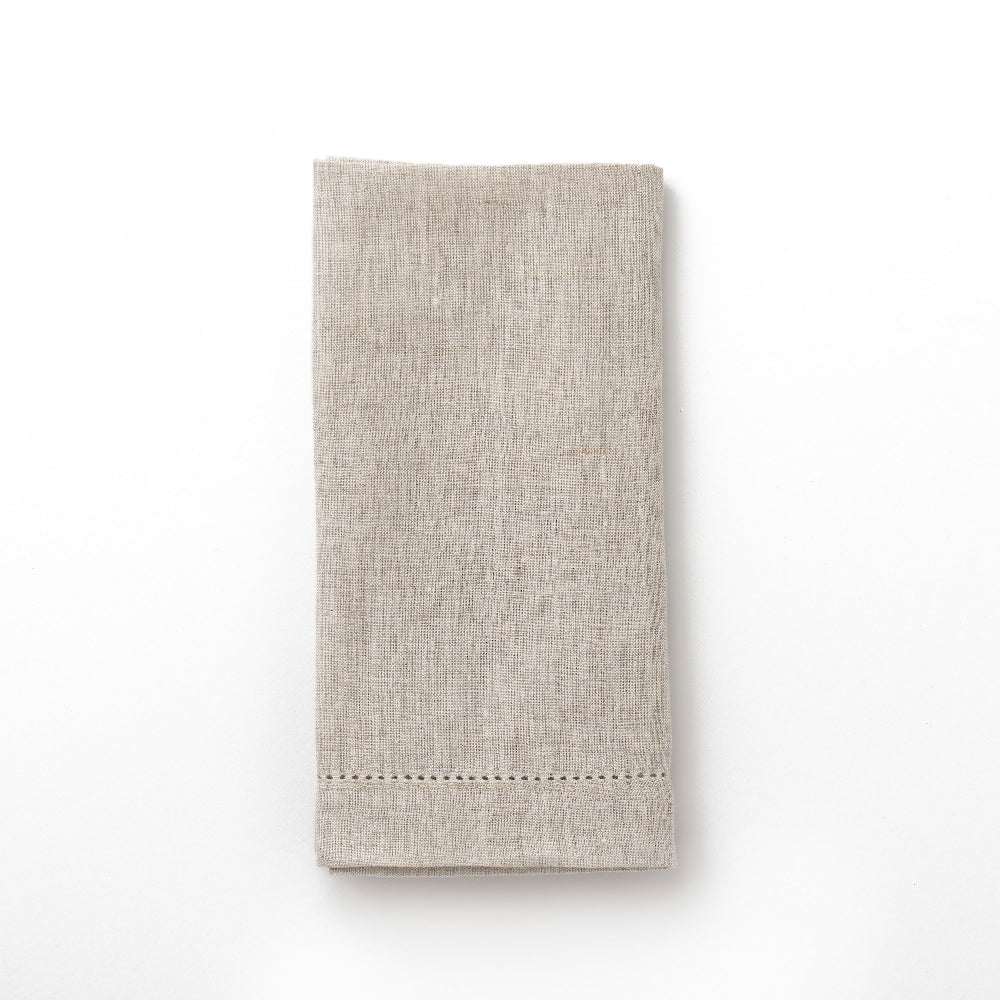 Folded beige napkin on a white background