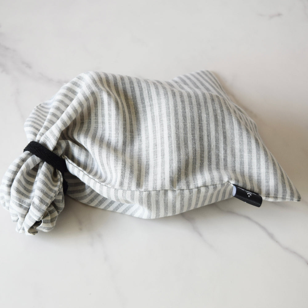 Striped fabric linen sourdough bag with drawstring on a white surface