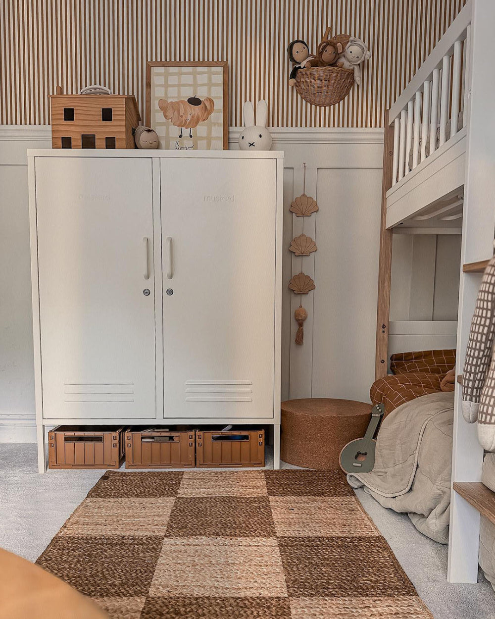 Children's room with a white cabinet, toys, and a bed.
