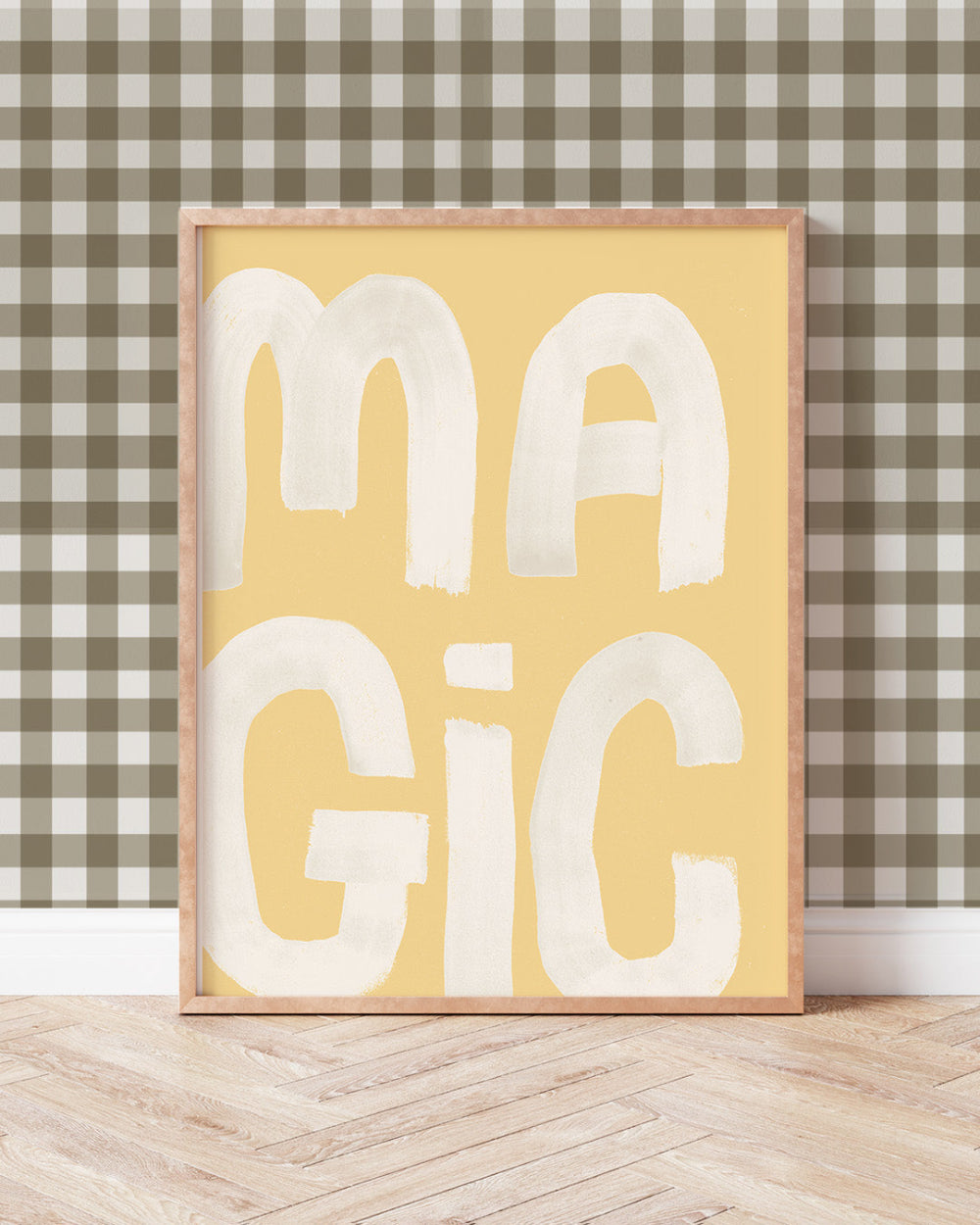 Framed artwork with 'MAGIC' text on a yellow background against a checkered wall.