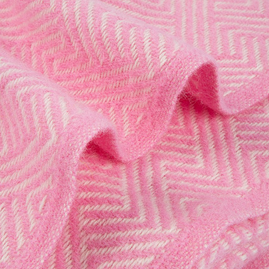 Close-up of pink herringbone blanket with a subtle pattern