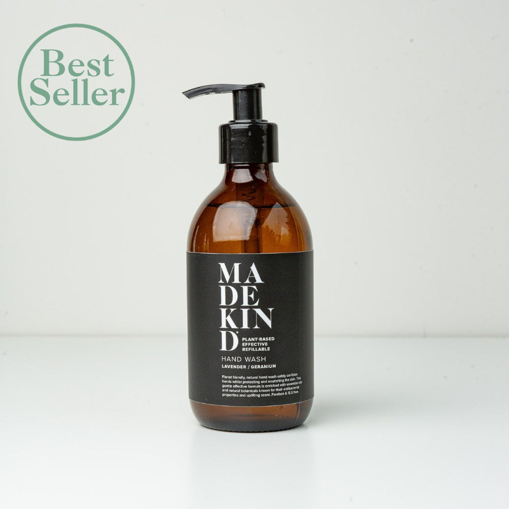 Brown bottle of Madekind hand wash with a black label on a white background