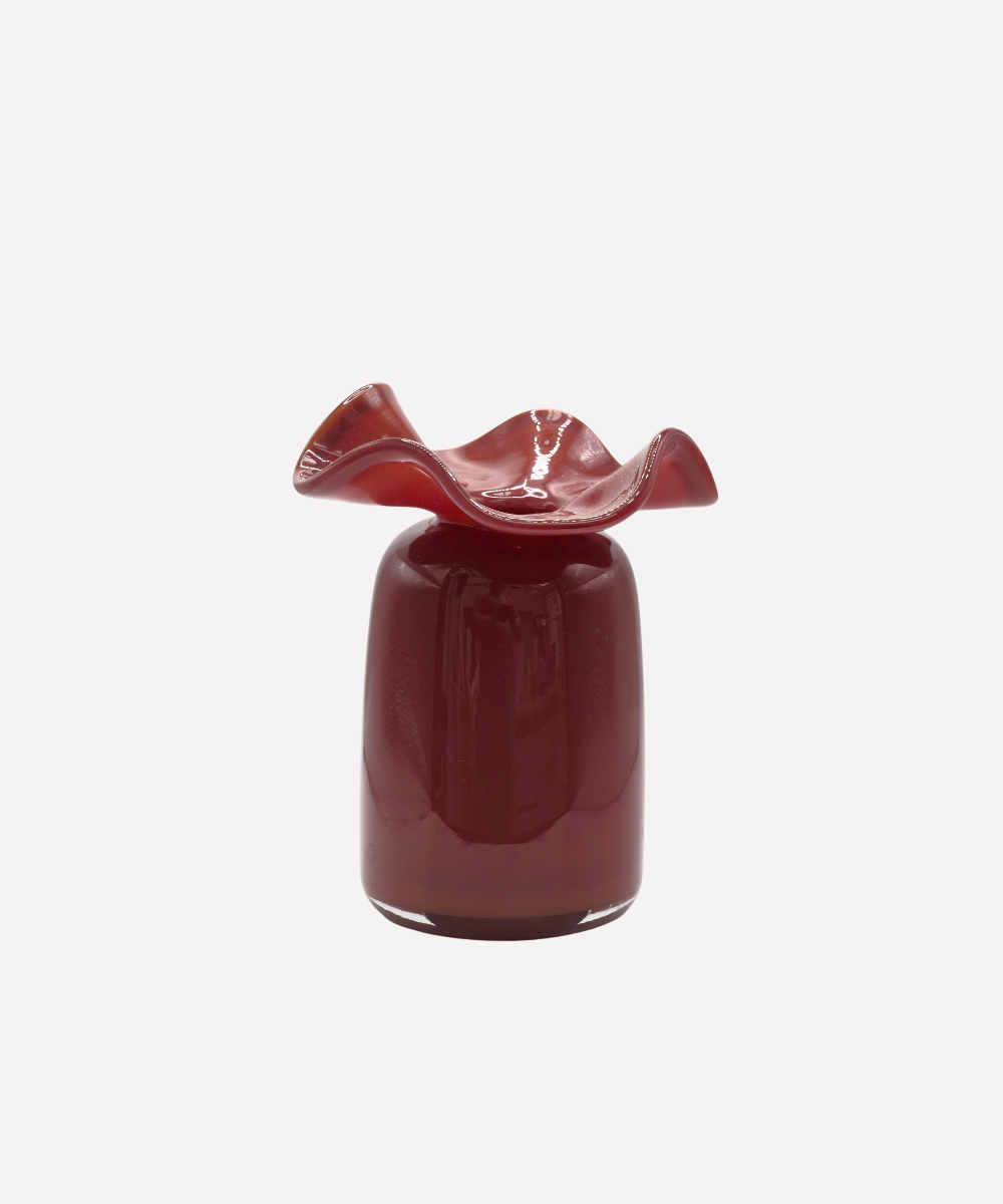 Brown glass vase with wavy top on a white background