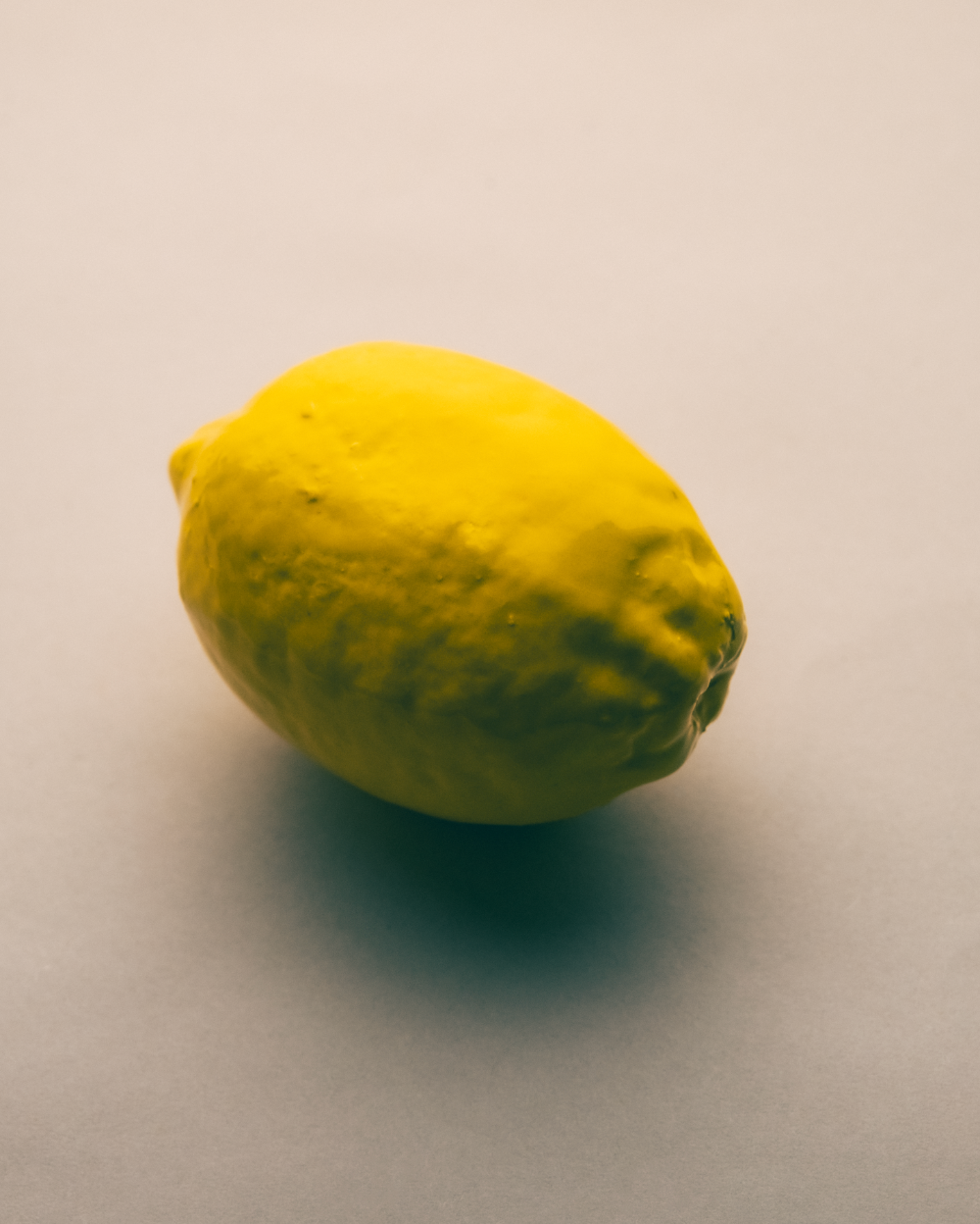 Handmade Ceramic Yellow lemon on a beige background