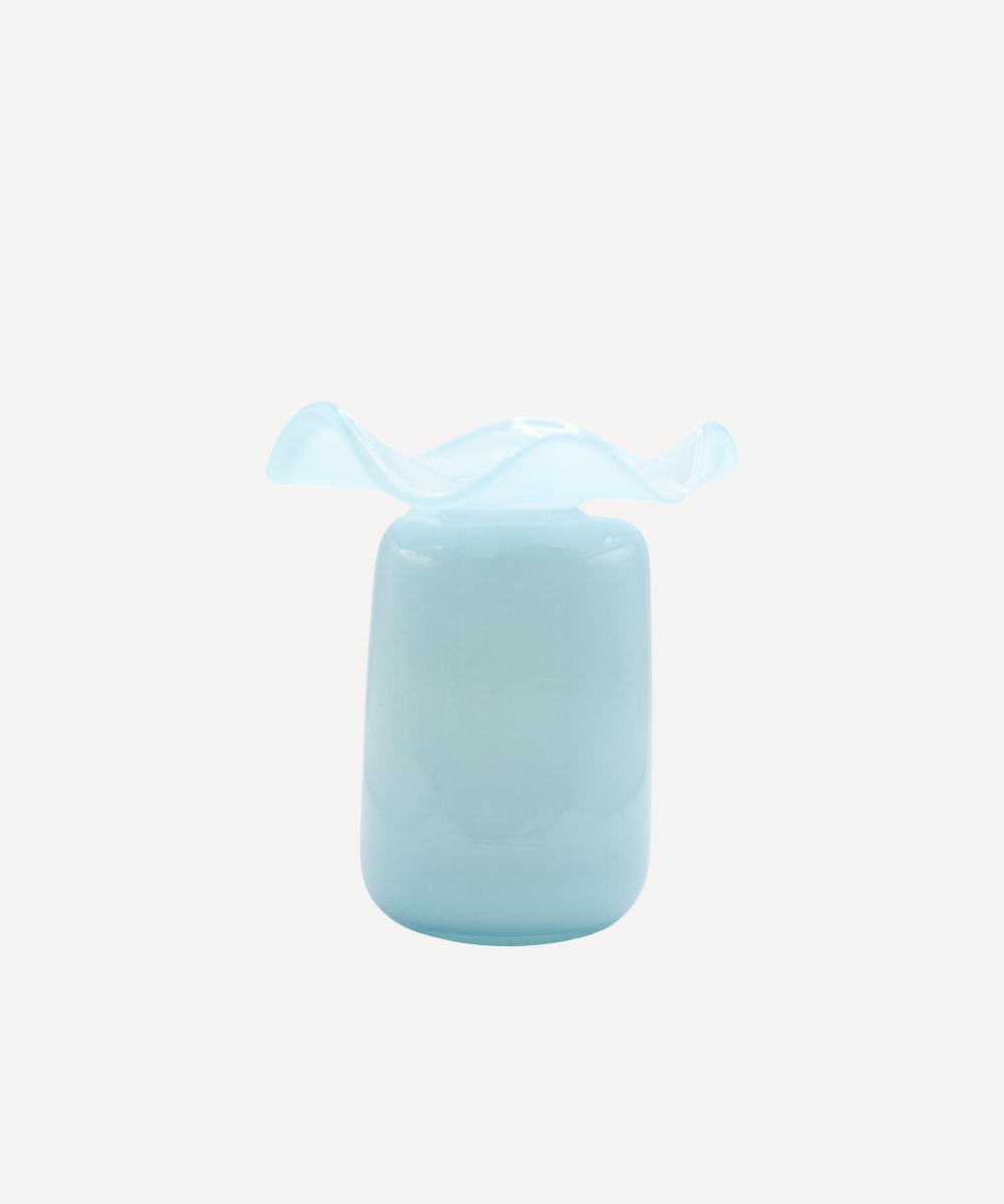 Light blue ruffle bud vase with a decorative bow on a white background