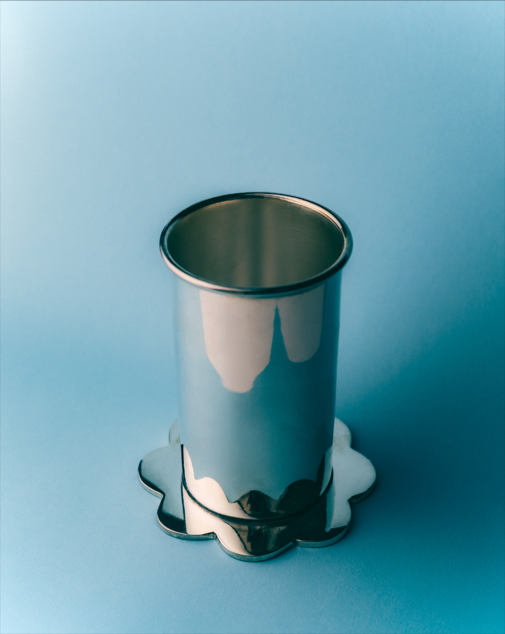 Scallop Silver plate tumbler on a blue background