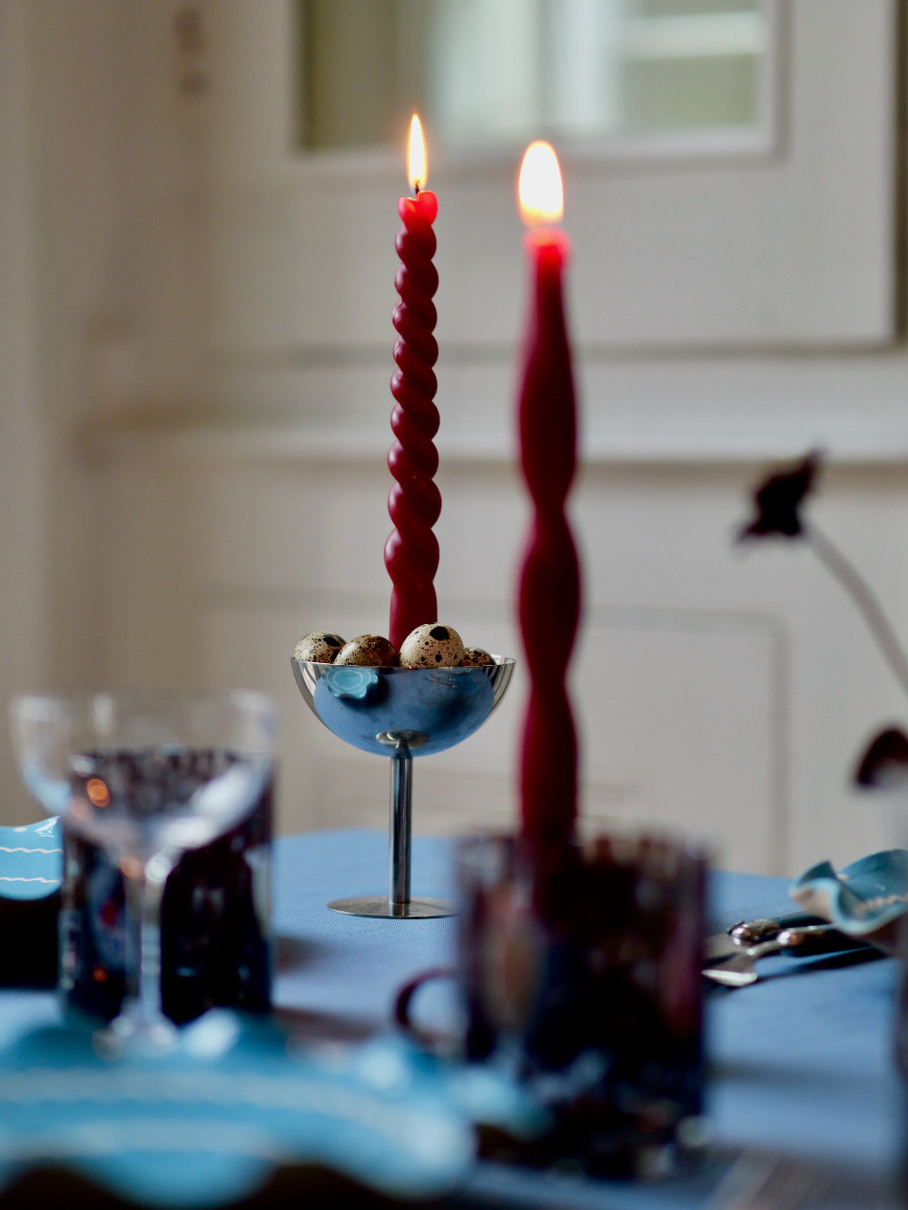 Red spiral candles on a table with a blurred background