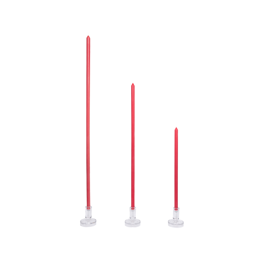Three Rhubarb coloured candles for interior design tablescapes with white bases on a white background