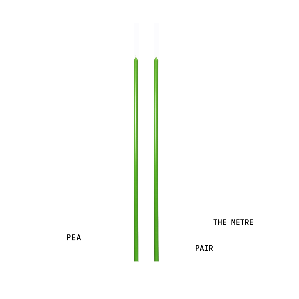 Pea coloured tapered handpoured candles a metre long for tablescapes on a white background