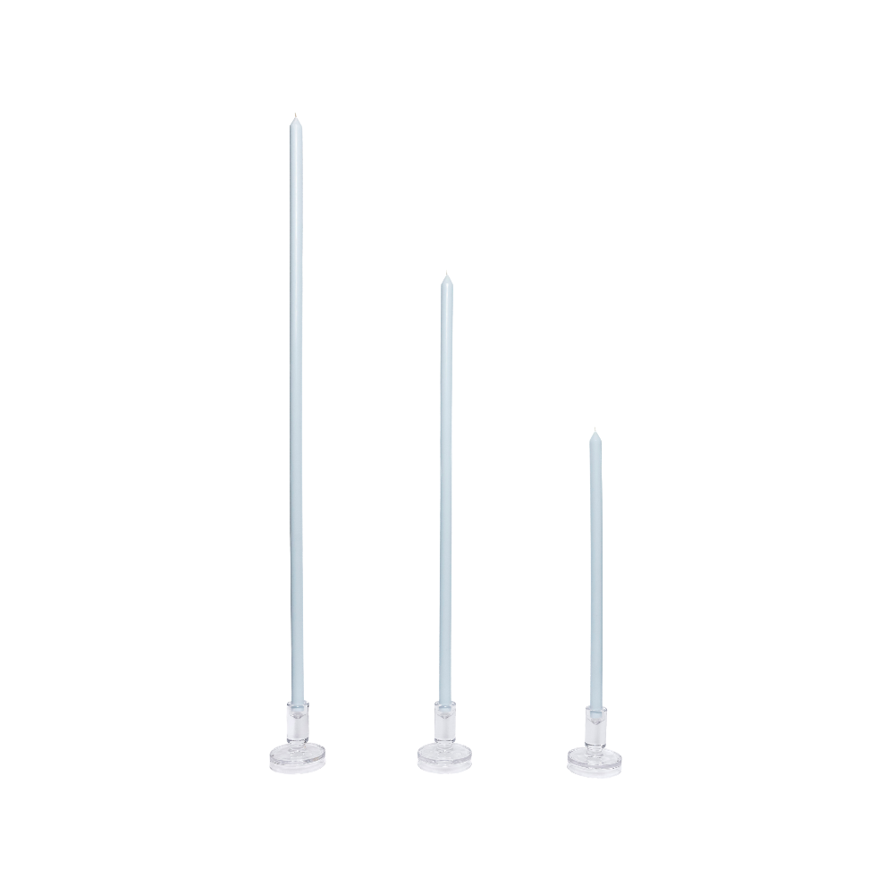 Three milky blue candles with clear holders on a white background