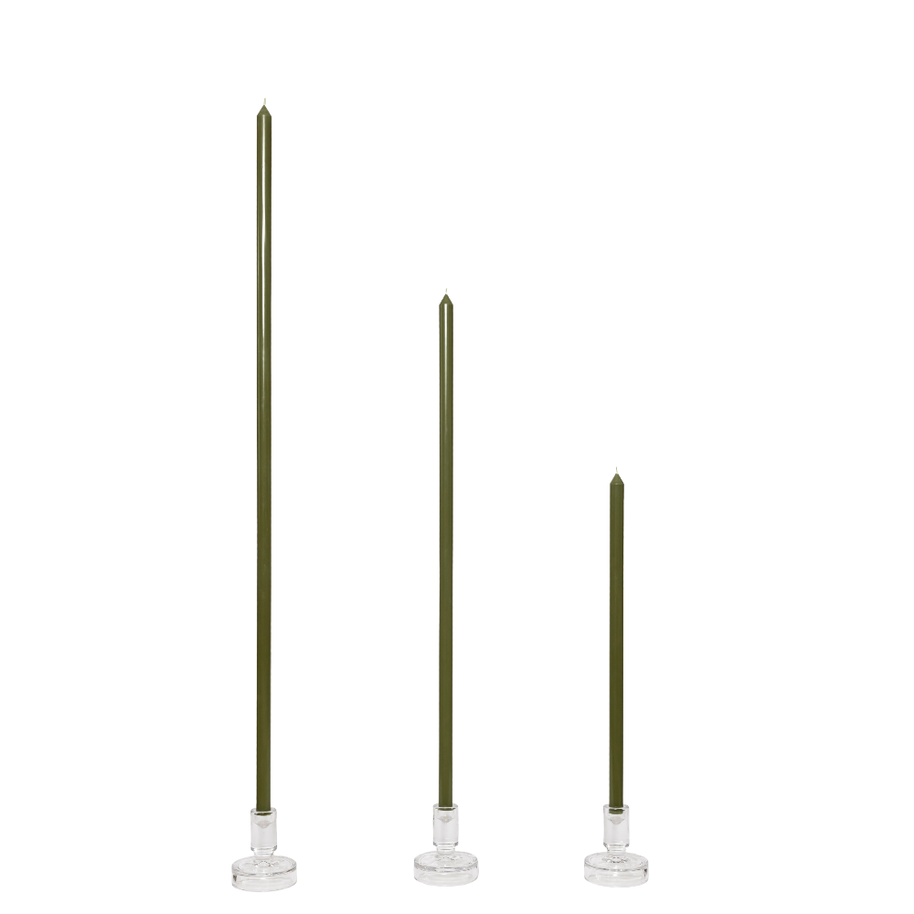 Three Olive green hand poured tapered candlesticks with glass candlestick holders on a white background