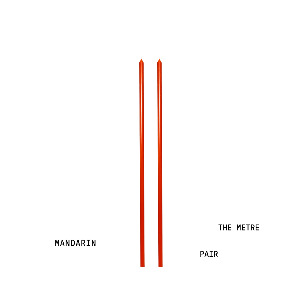 Two orange tapered candles with text 'Mandarin' and 'The Metre Pair' on a white background