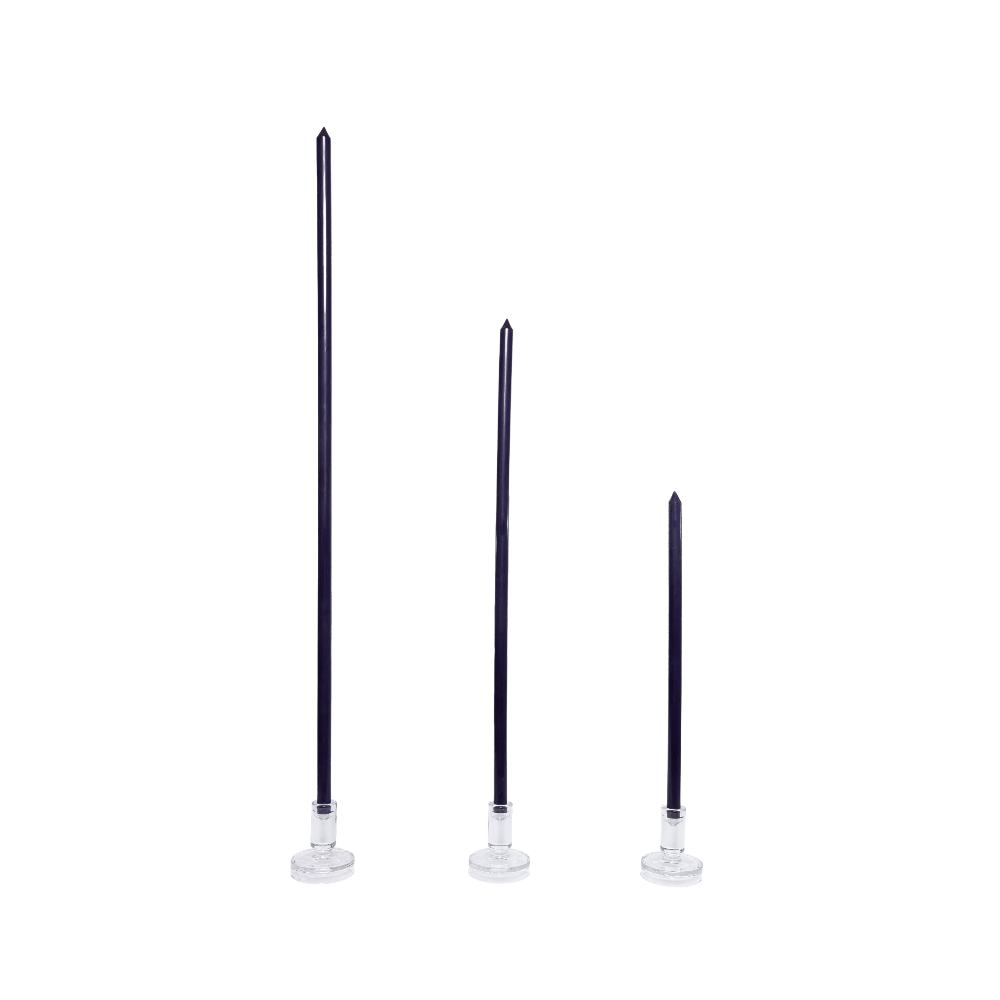 Three Midnight Blue candles with silver bases on a white background