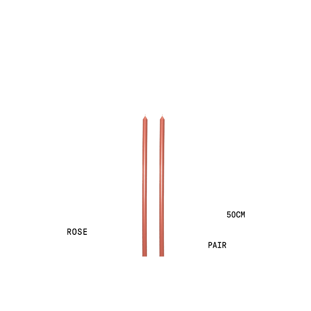 Two rose-coloured candlesticks with measurement text on a white background