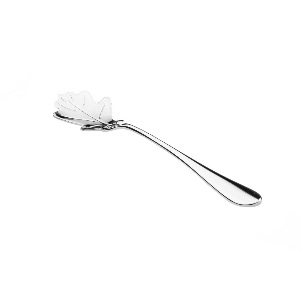 Silver spoon with decorative head on a white background
