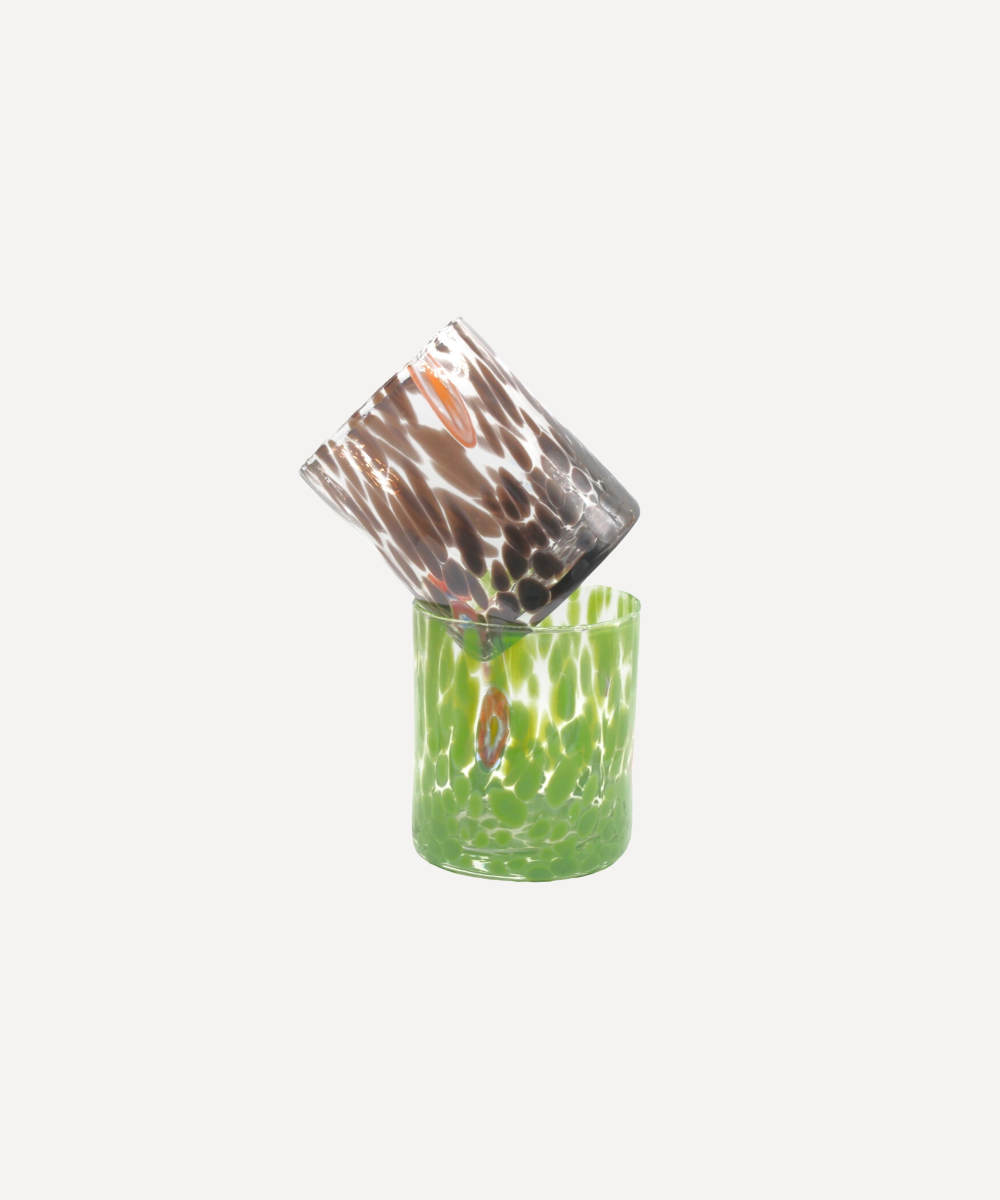 Two glass tumblers with camouflage and green patterns on a white background