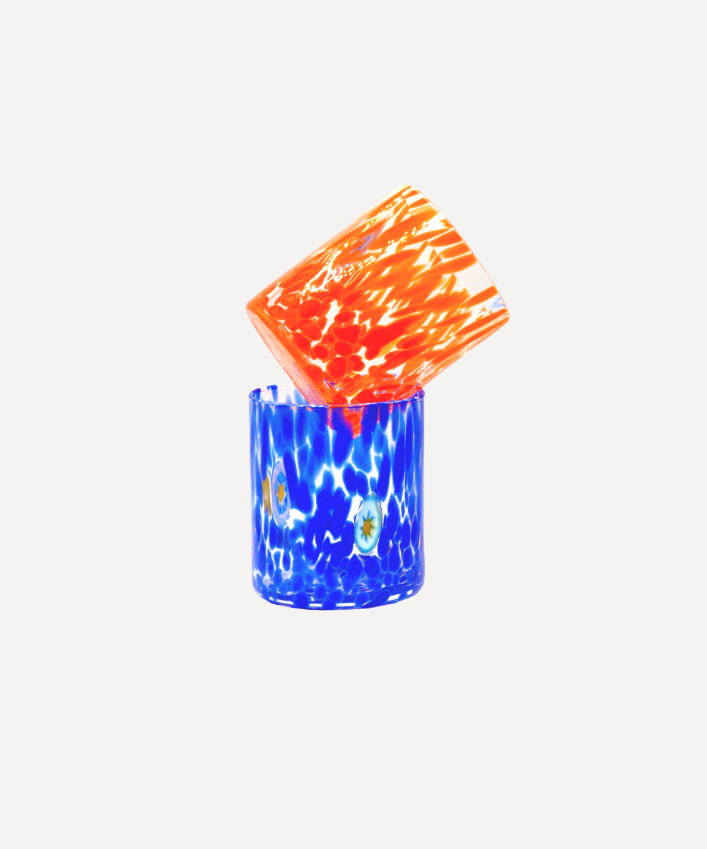 Blue and orange murano glass tumblers on a white background