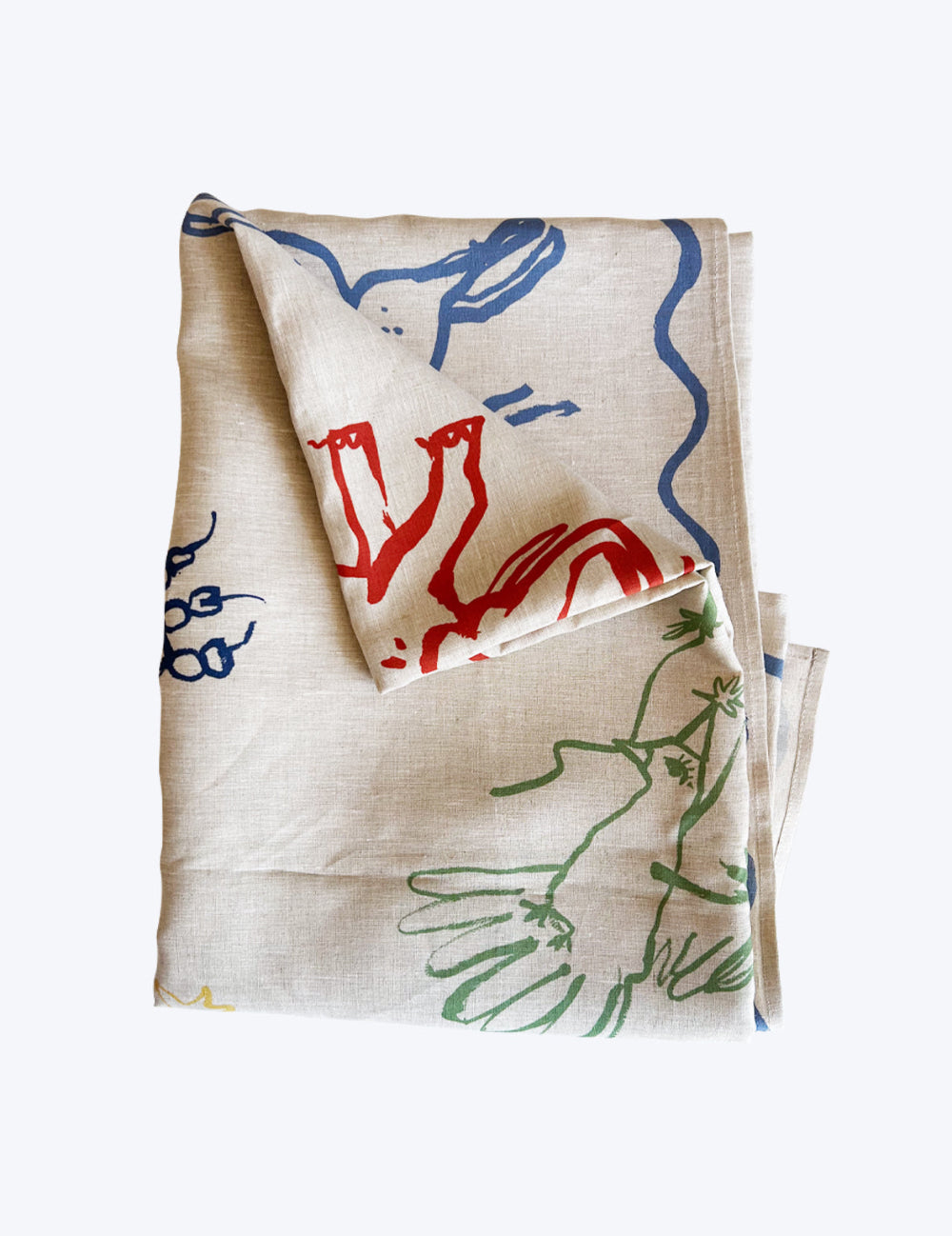 Folded Birthday Linen tablecloth with colourful abstract designs on a white background