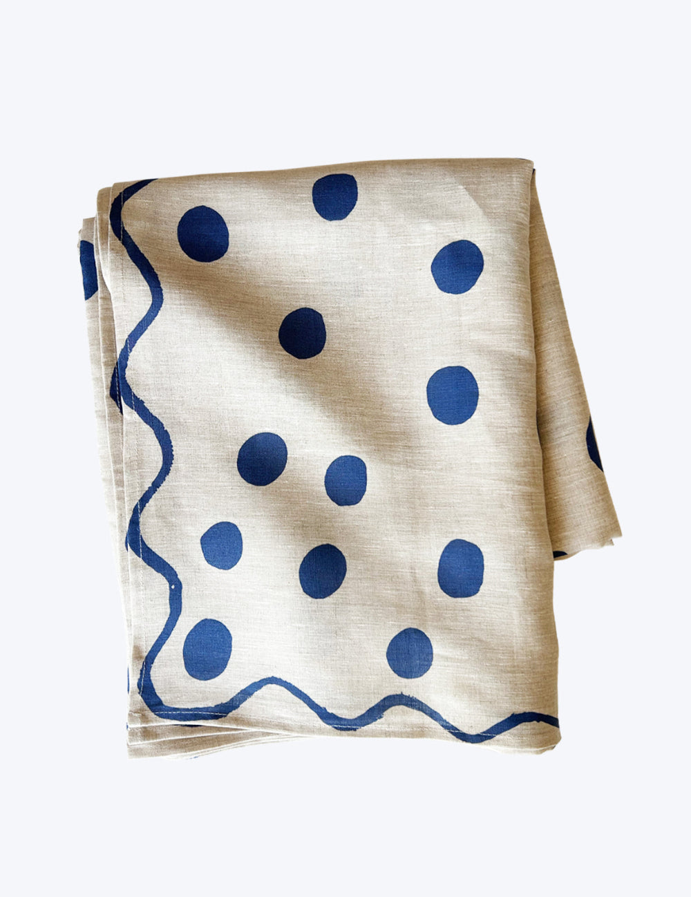 Linen polka dot tablecloth with blue polka dots and wavy lines on a white background