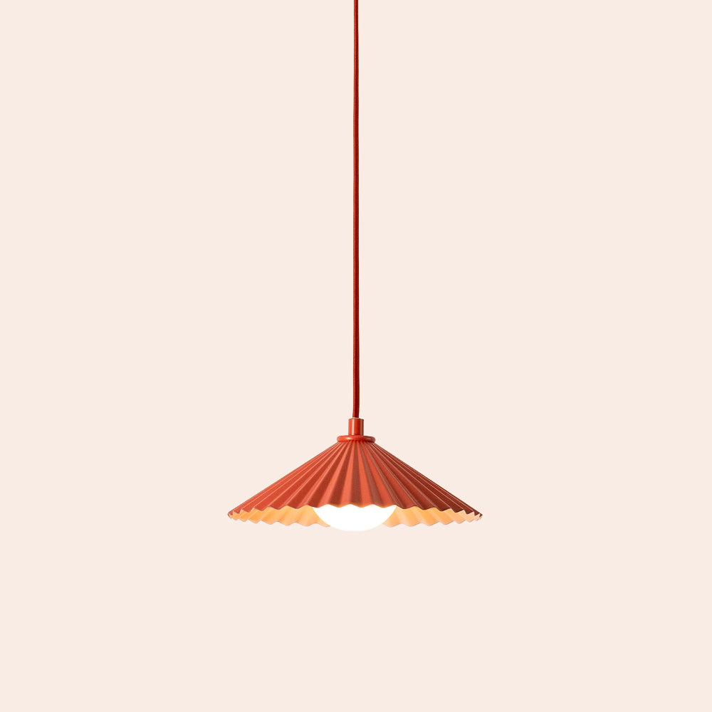 Orange pendant lamp with a unique design on a beige background
