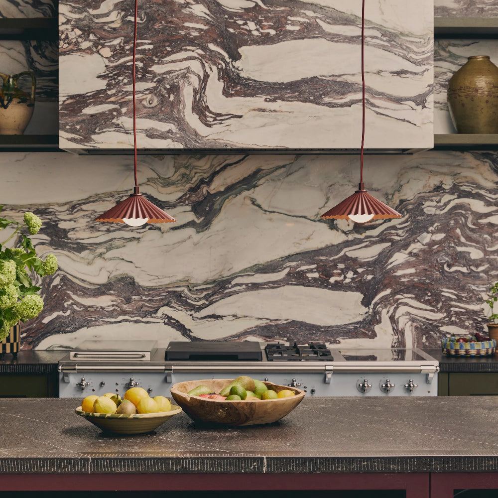 Burnt orange pendant light styled above a kitchen island
