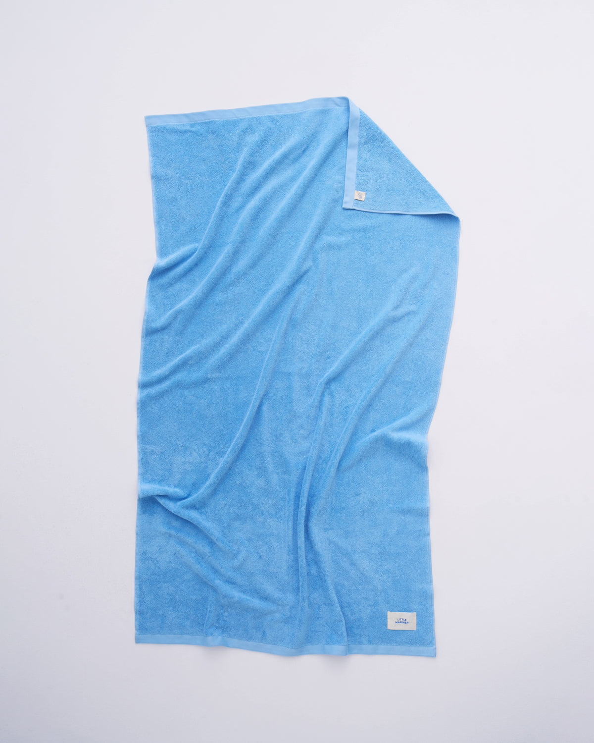 Soft coastal blue beach towel for poolside and summer holidays