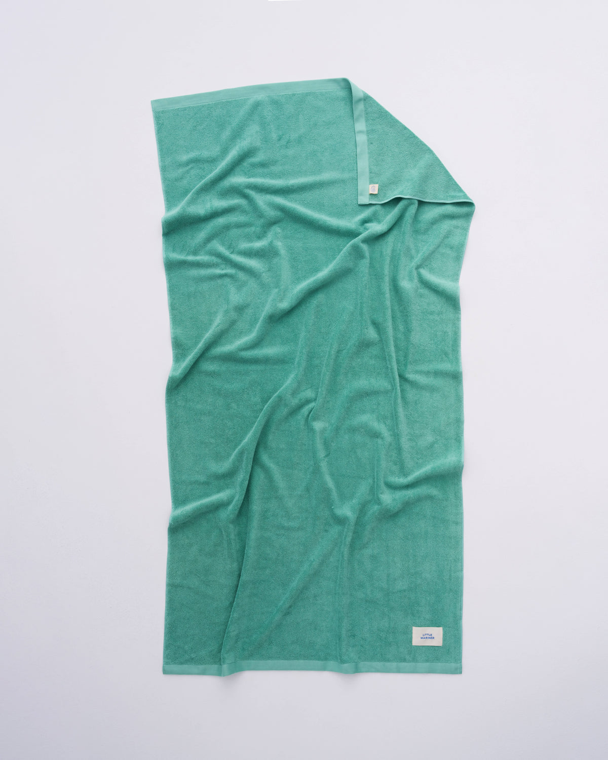 Soft sage green beach towel for poolside and summer days